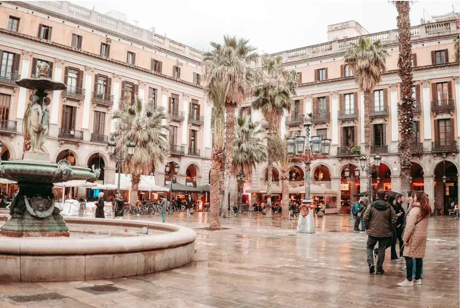People gathering in Plaça Reial on the Barcelona walking route